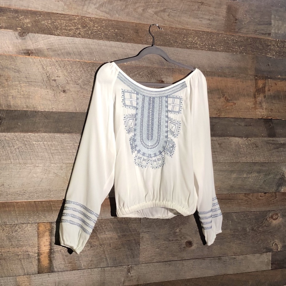 NG the label white blouse with blue design